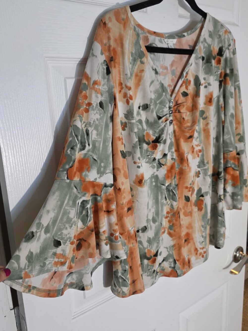 EST 1946 Chic floral blouse with a flattering V-neck. Features stylish bell slee